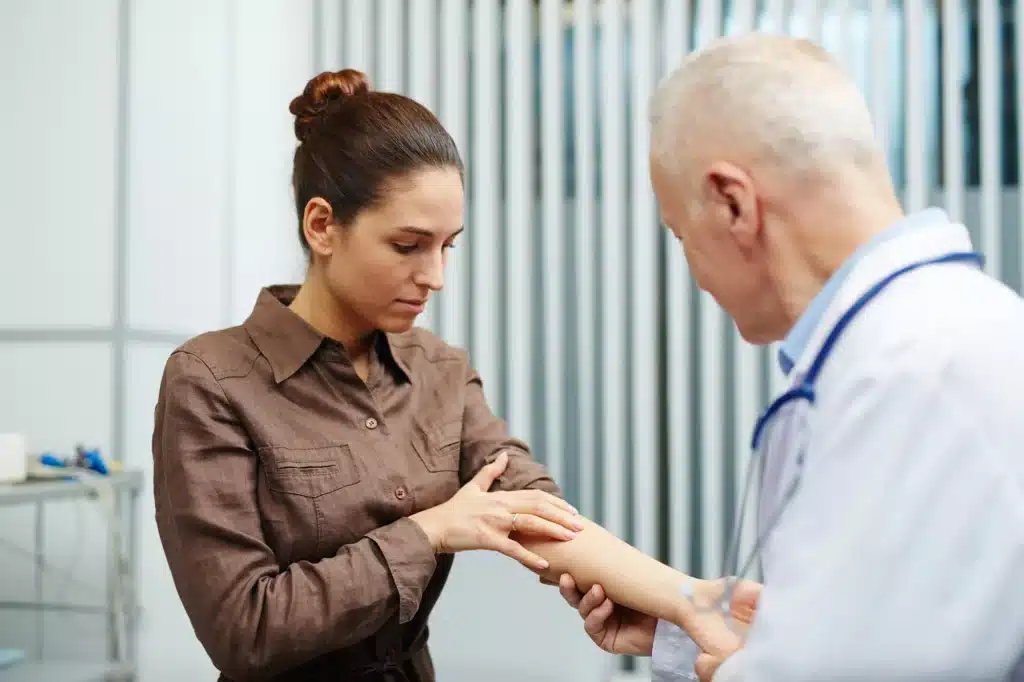 Woman talking to doctor about numbness in her arm