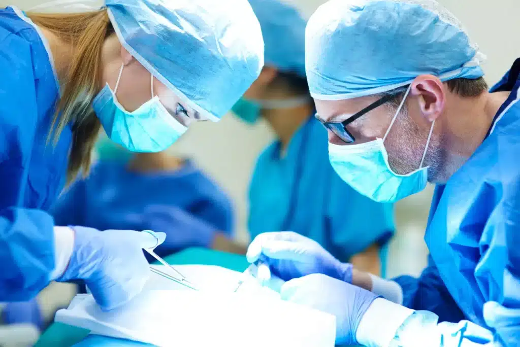 Doctors performing surgery on a patient