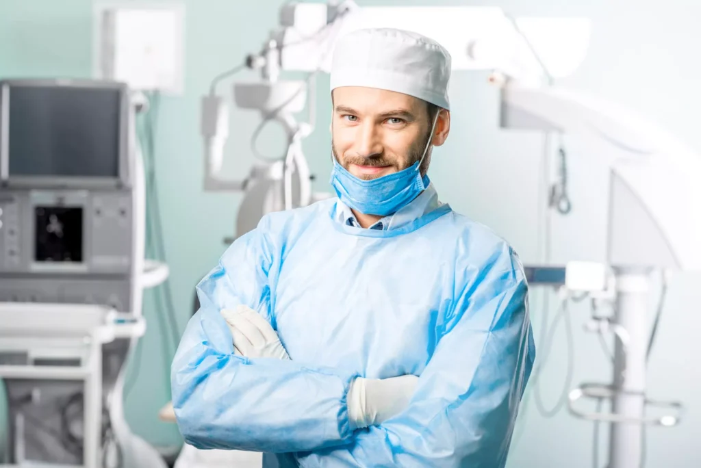 Doctor folding his arms posing for a photograph in surgical equipment