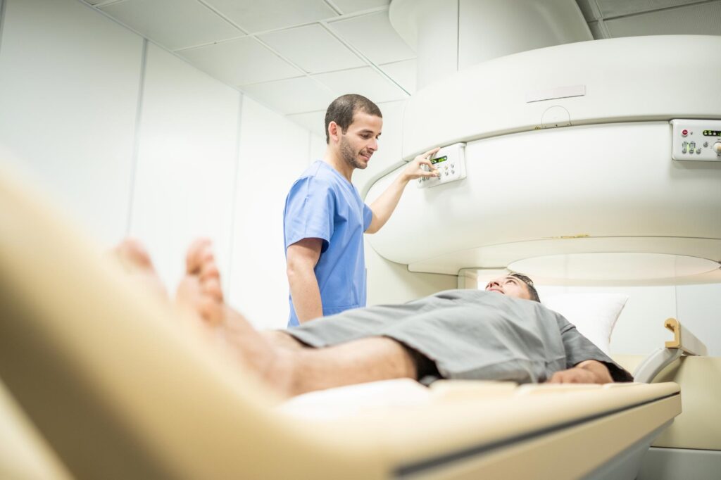 Nurse performing a CT Scan on a patient