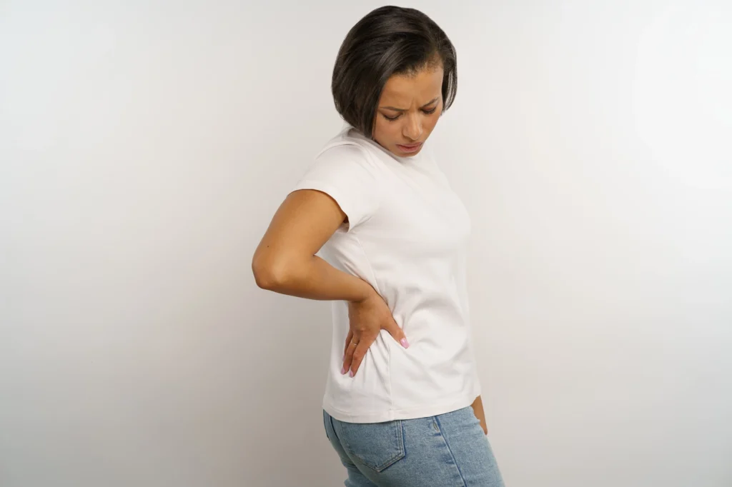 Woman holding her lower back as if she has back pain