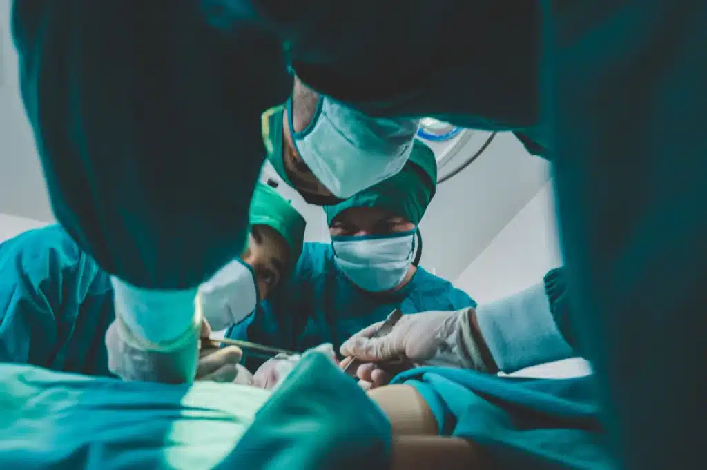 Doctors performing minimally invasive surgery on a patient