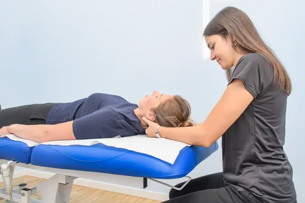 Physical therapist treats a patients neck