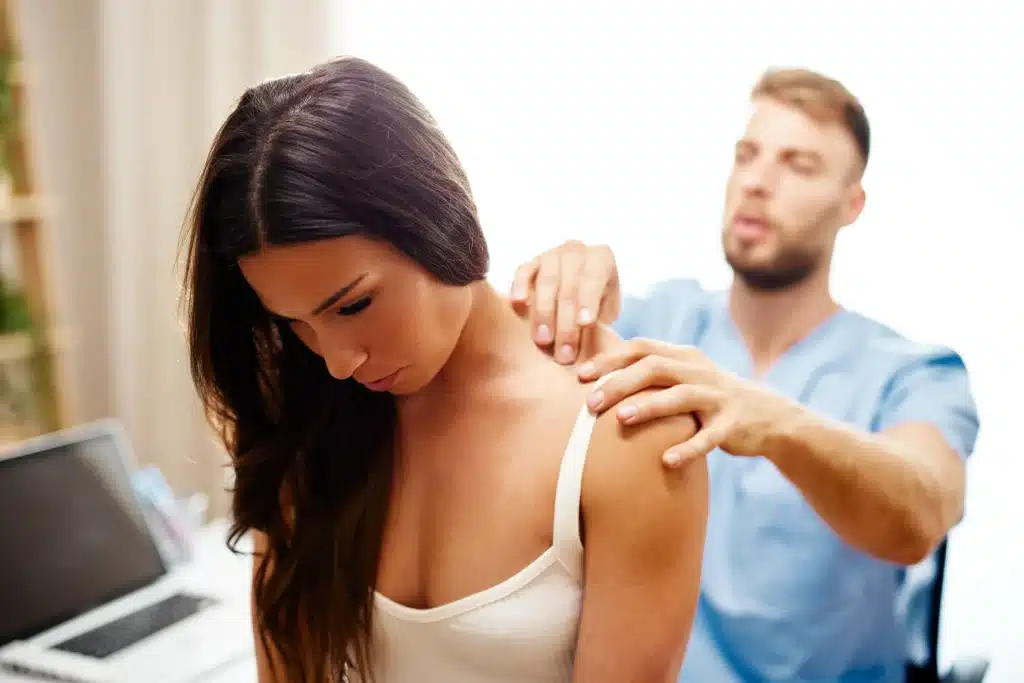 Woman with neck pain being treat by a specialist