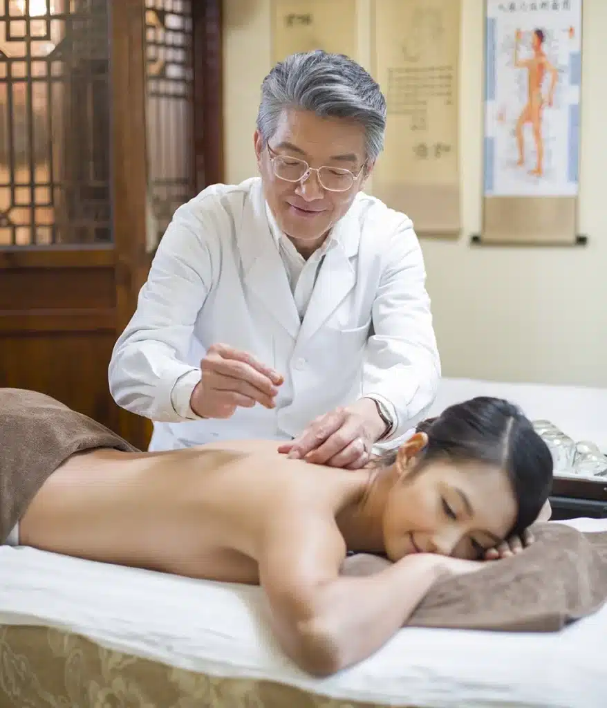 Doctor doing acupuncture treatments on a patient