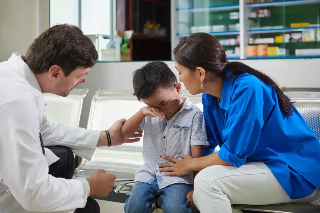 Boy crying during consultation with the doctor