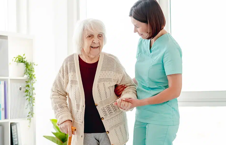 Therapist helping a senior woman to walk