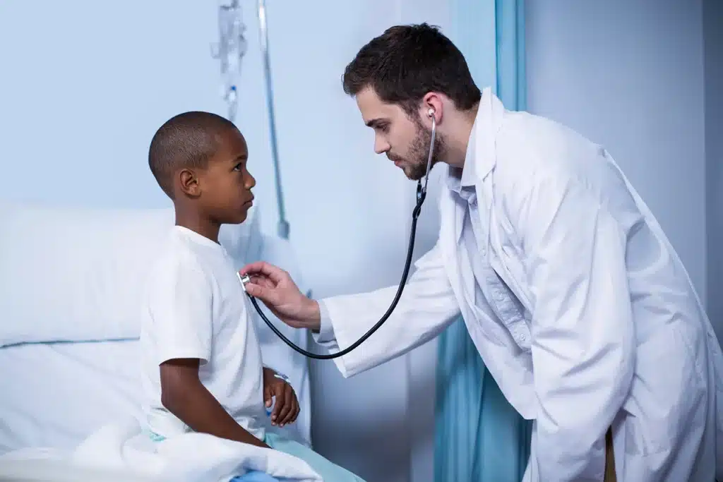 A doctor examining a child in the hospital
