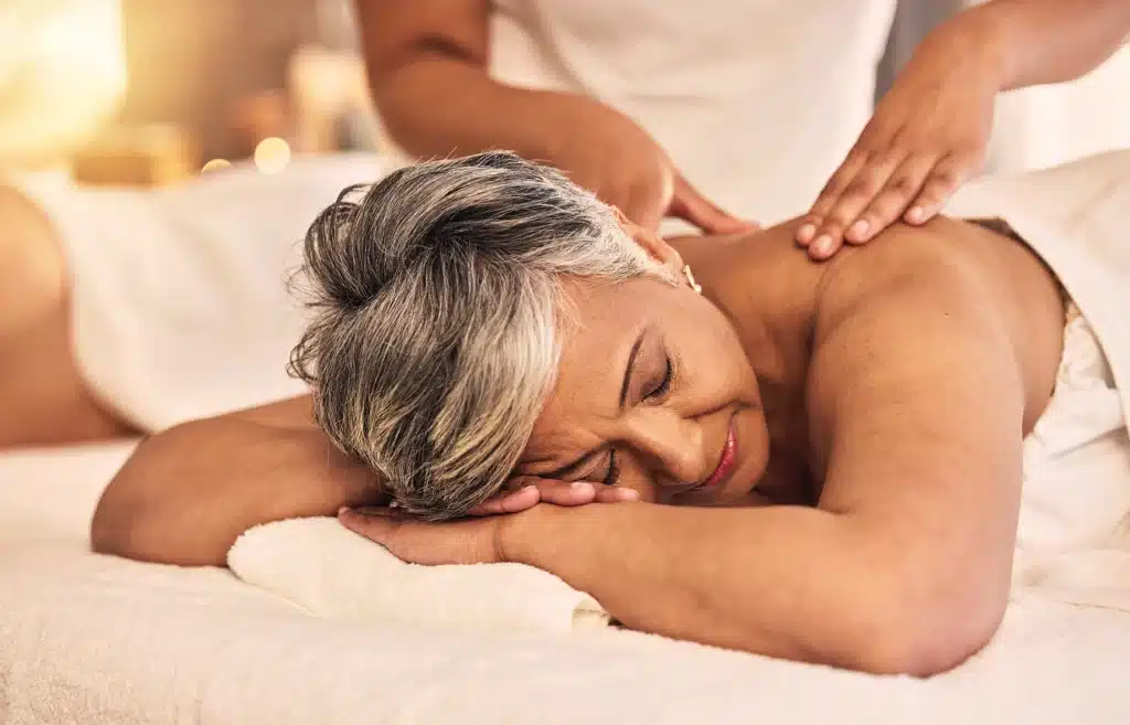 Senior woman being treated with a massage