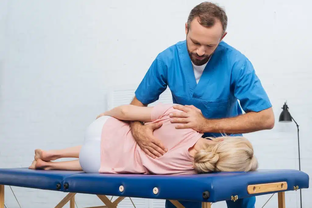 Woman being treated by a chiropractor