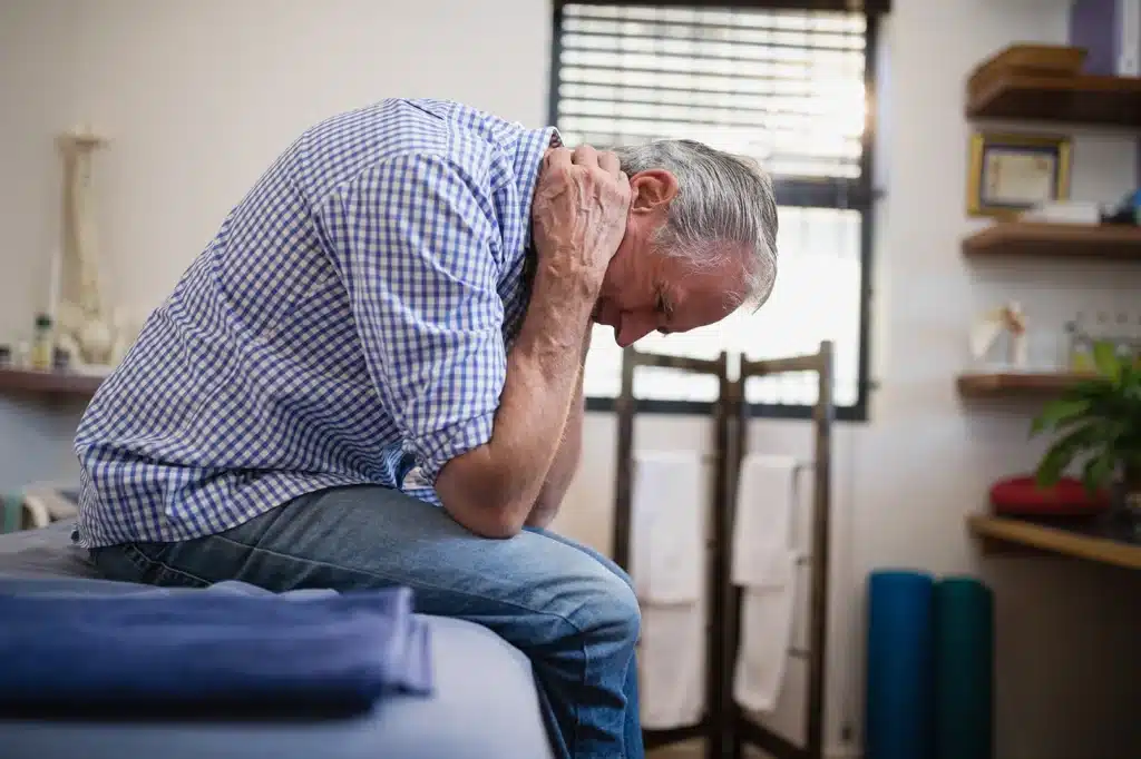 Elderly man suffering nerve damage pain