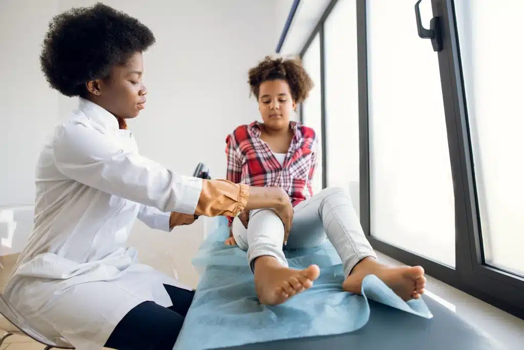 Therapist treating a girl's knee