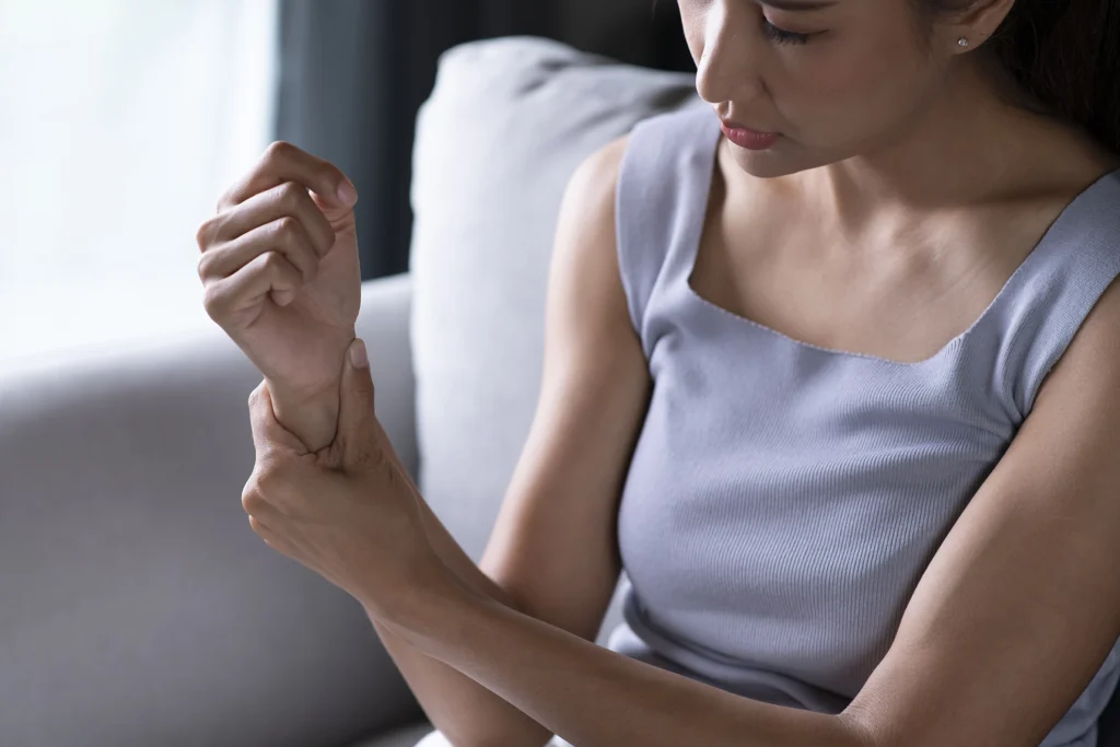 Woman holding her wrist joint in pain