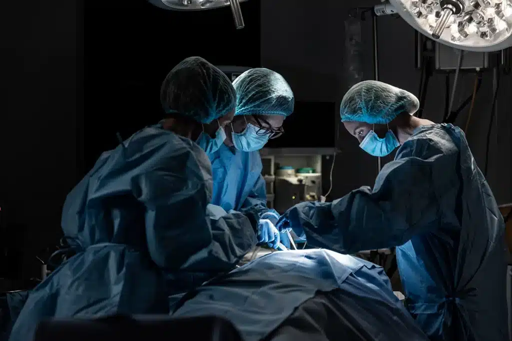 surgeons performing surgery on a patient