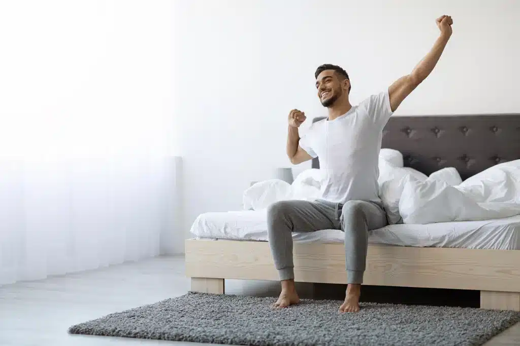 Man waking up stretching his arms