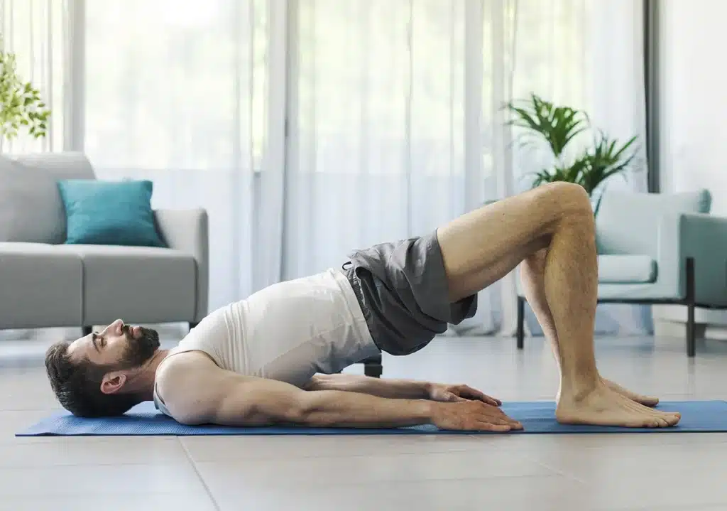 Man practicing glute bridge excercise for pain relief