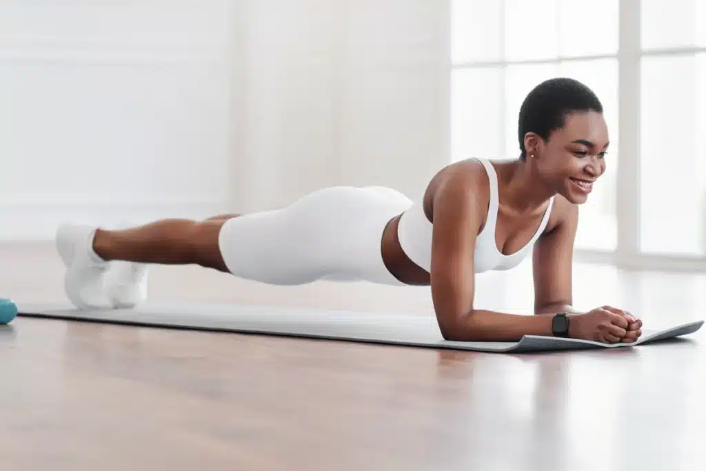 Young woman practicing plank