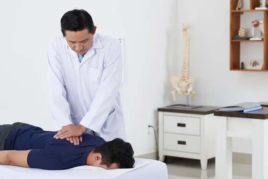 Male patient being treated by a chiropractor