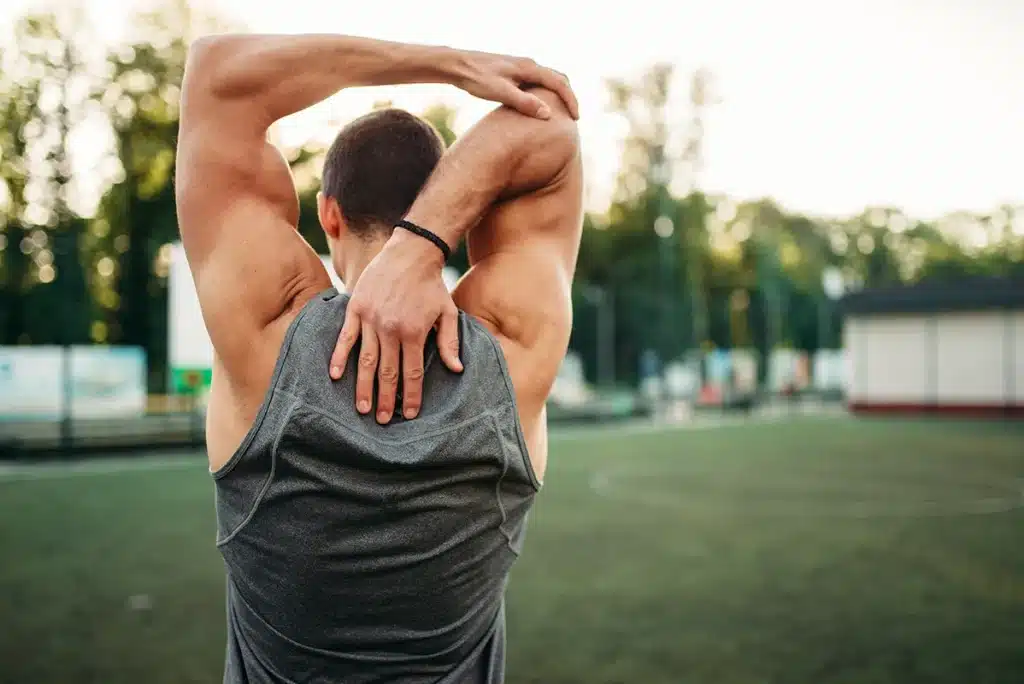 Athletic man stretching his back