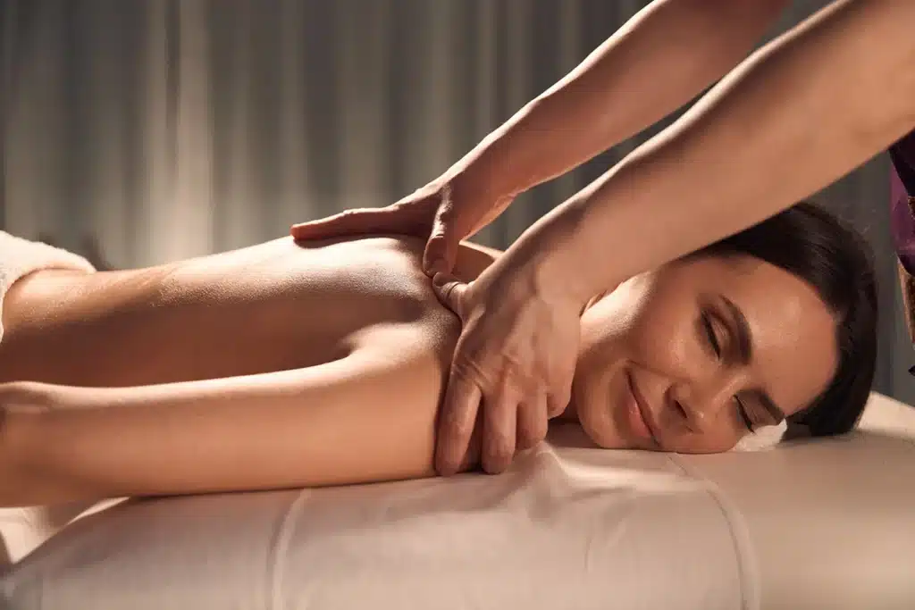 masseuse massaging back pressure point
