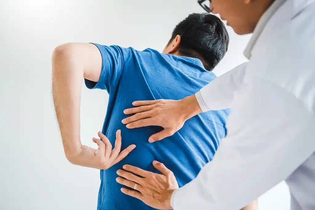 Back pain specialist doctor examining male patient