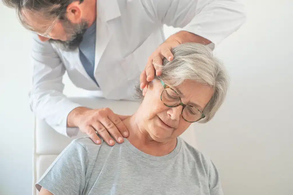 Elderly woman in consultation with a pain management doctor