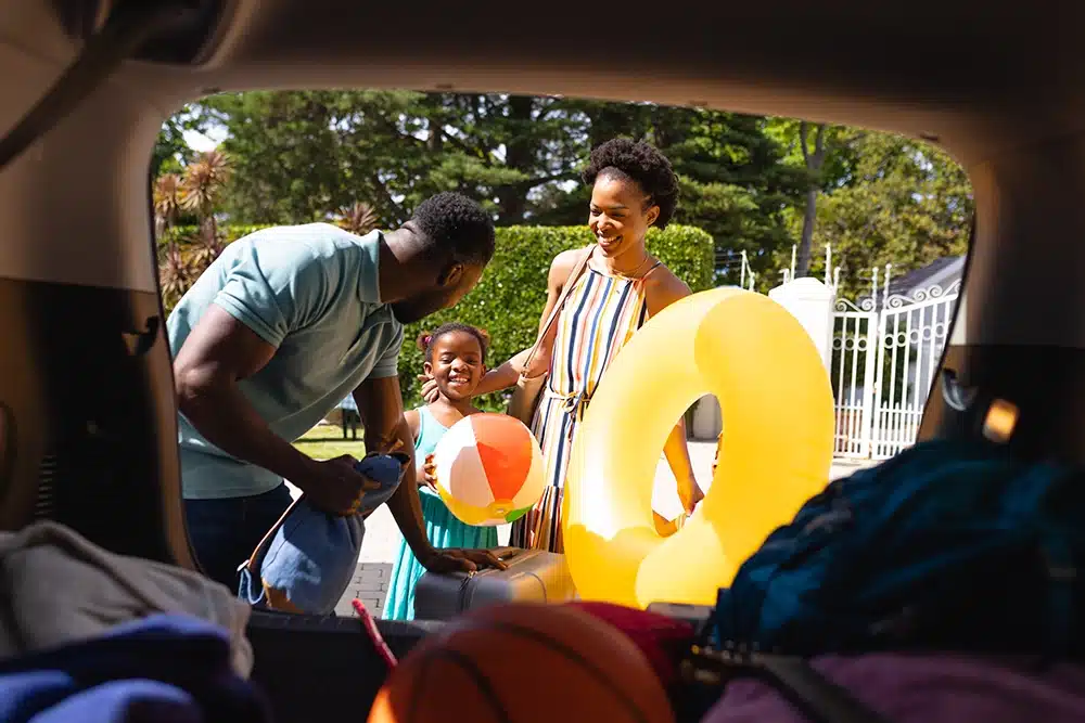 A family packing a car for a vacation trip