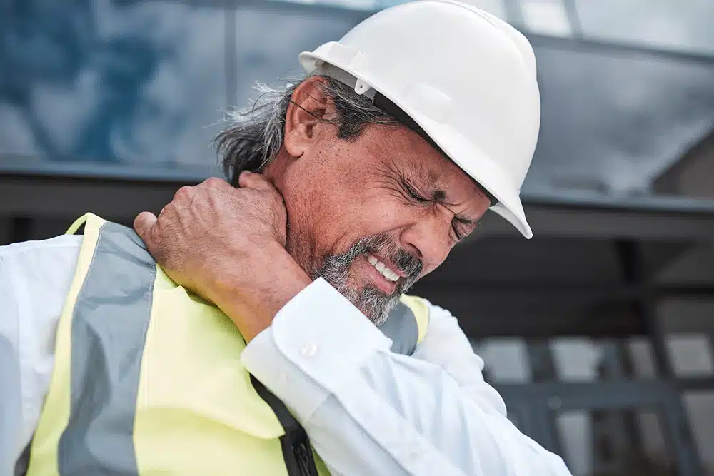 Man working construction with back pain