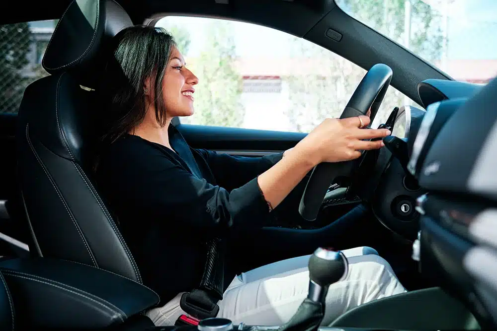 woman happily driving a car