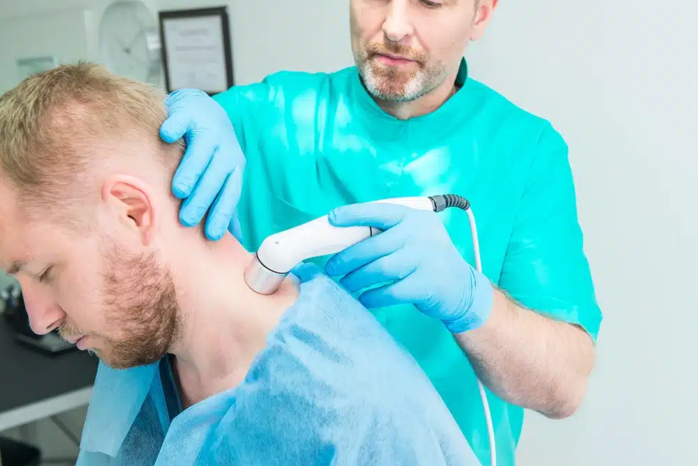 laser treatment being applied for a mans neck pain