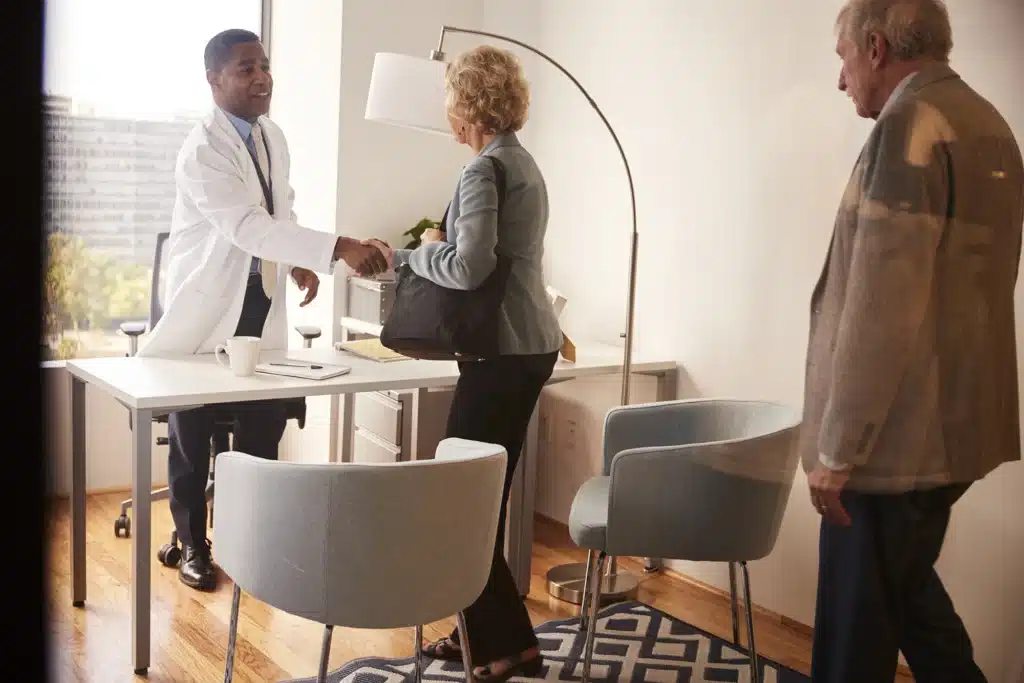 Doctor Greeting Senior Couple for Consultation