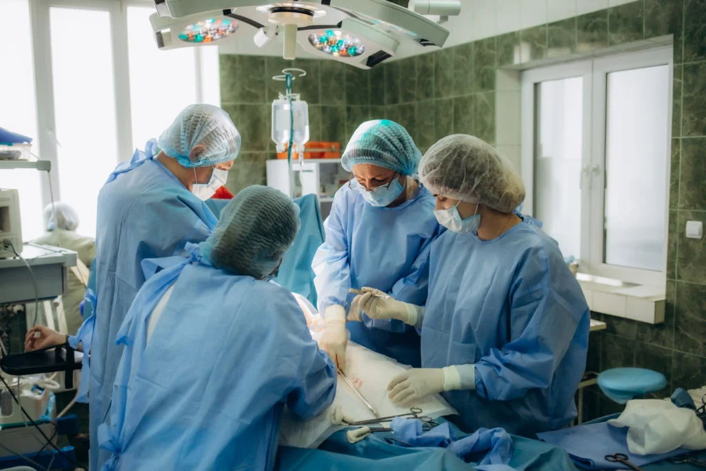 Surgical team performing an artificial disc replacement procedure in the operating room.