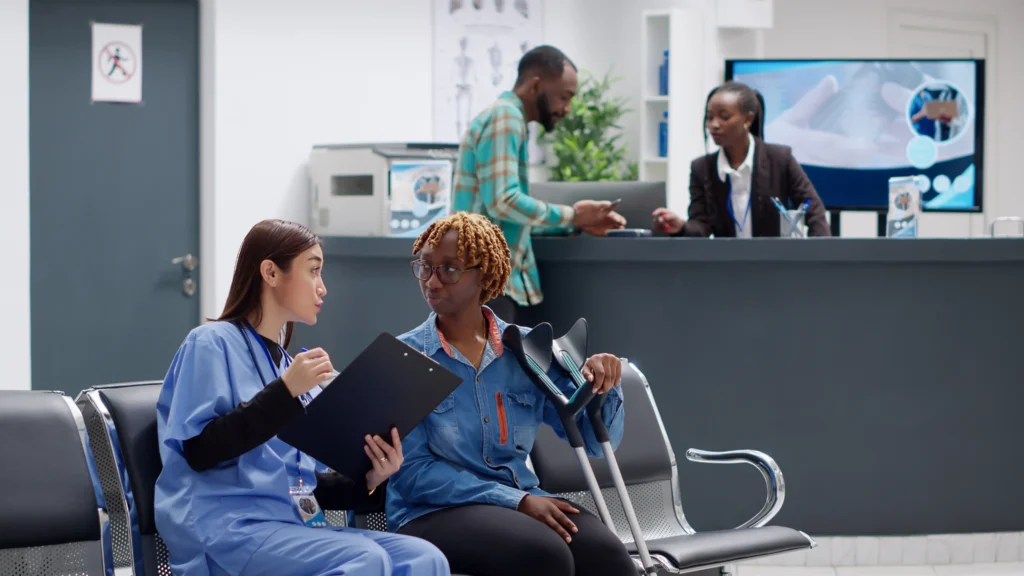 Patient consulting a nurse about spinal fusion surgery costs and recovery.