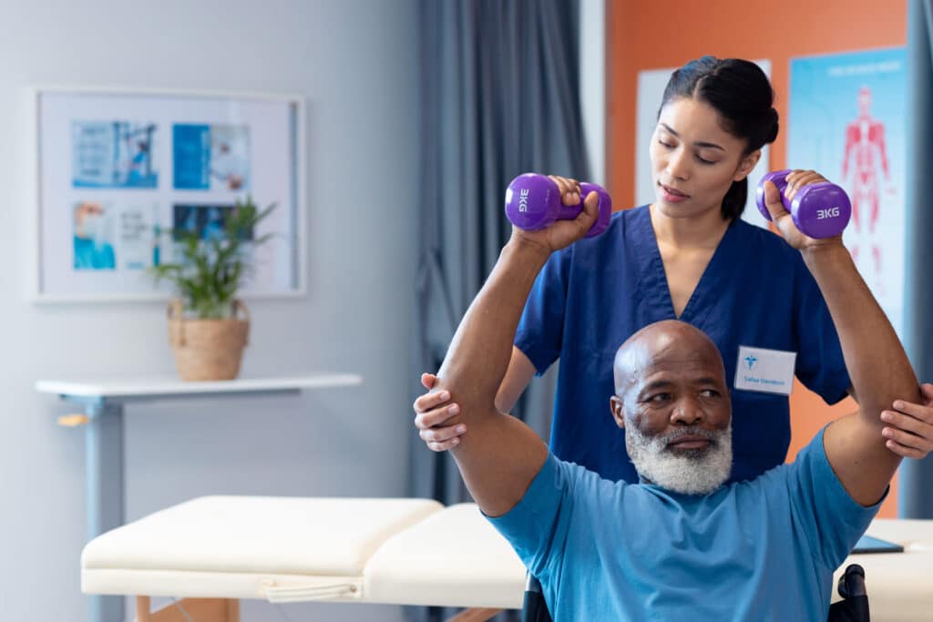 Female physiotherapist assisting senior male patient in rehabilitation after spinal fusion surgery.