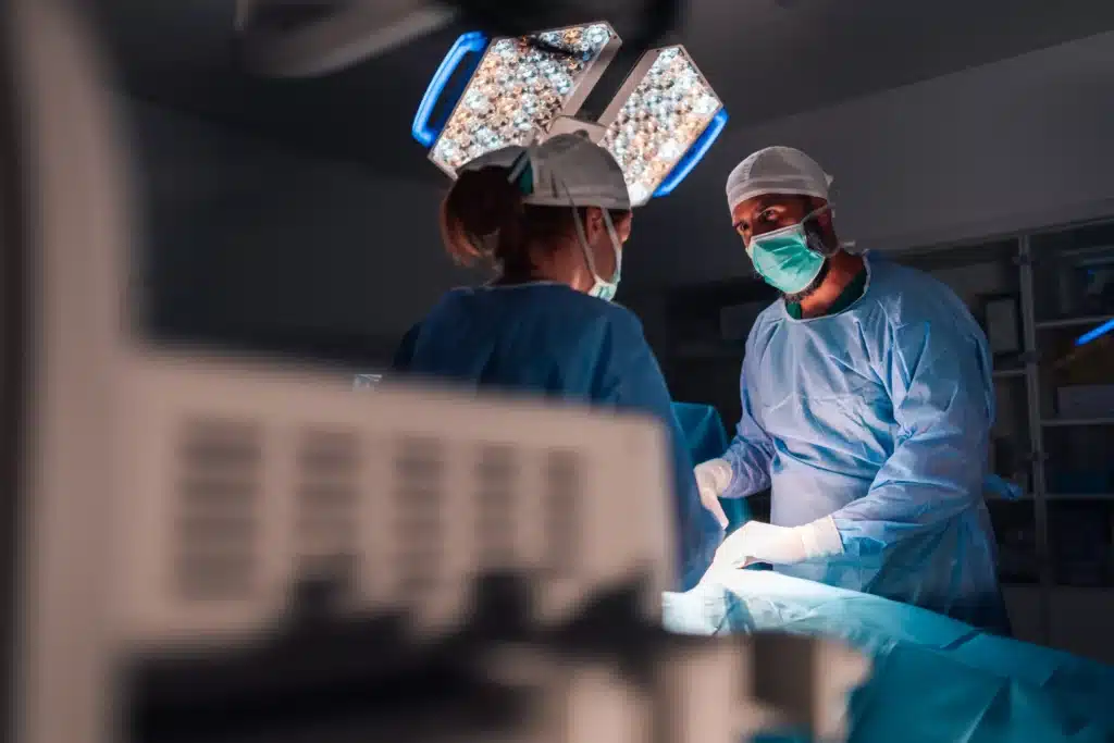 Surgeons performing minimally invasive spinal fusion surgery in a modern operating room.