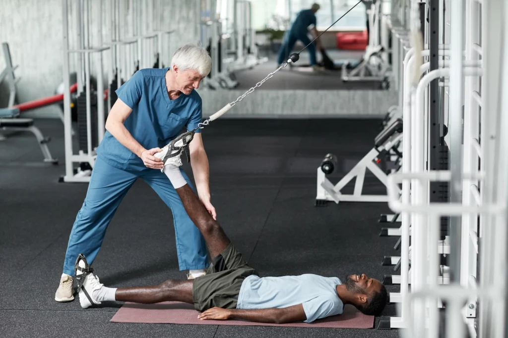 Patient in rehabilitation clinic following spinal fusion recovery protocol, guided by a physical therapist.