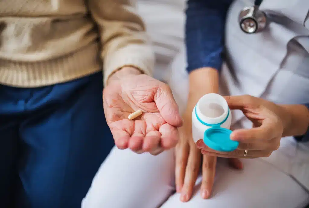 A healthcare provider explaining medication options to a senior patient, focusing on non-opioid pain relief alternatives.