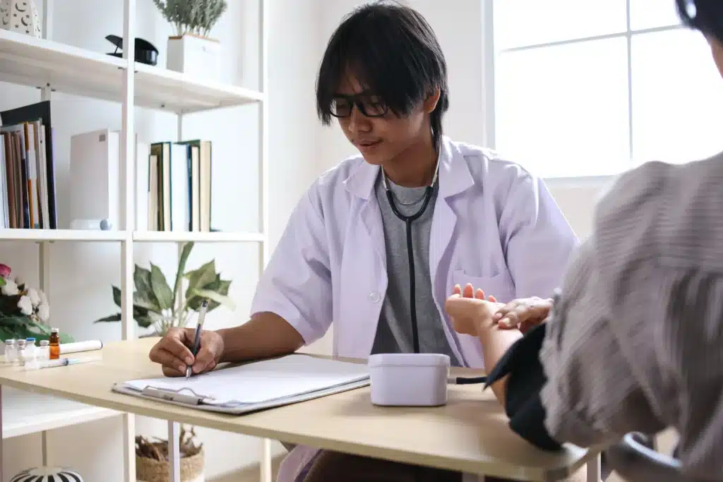 Doctor assessing a patient for nerve-related pain and taking blood pressure