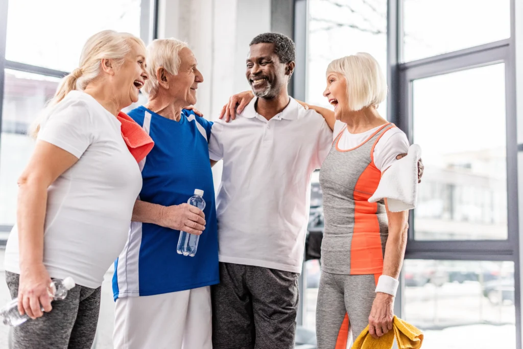 Happy senior adults in sportswear engaging in light exercise, promoting physical activity for pain relief.