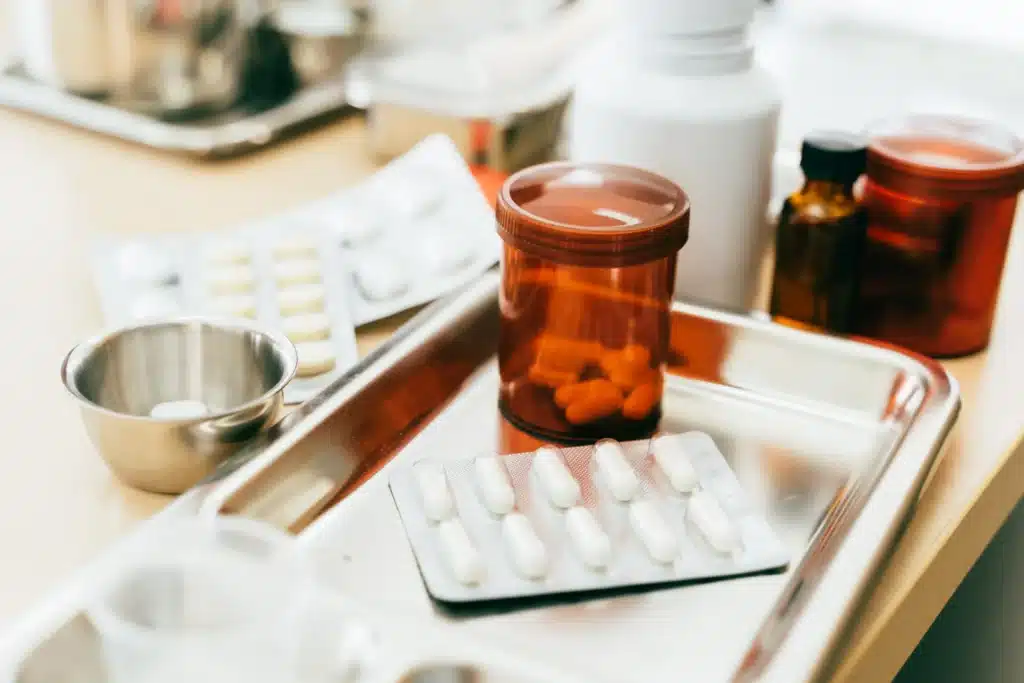 A hospital table displaying various medications, highlighting non-opioid drug options for pain management.