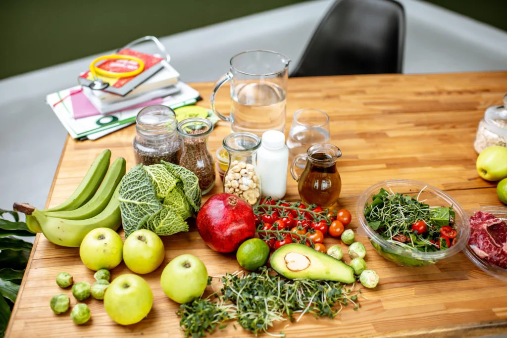 Fresh fruits, vegetables, and other healthy foods on a nutritionist's table, promoting dietary changes for oncological pain relief.