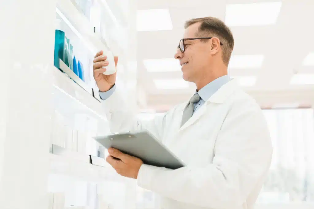 A pharmacist reviewing medication details on a clipboard, emphasizing non-opioid alternatives for pain relief.