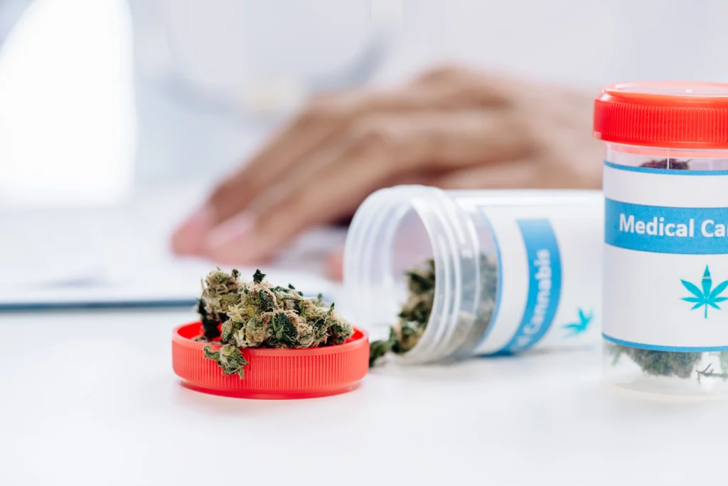 A container labeled medical cannabis with dried cannabis on a red cap, emphasizing safe usage.