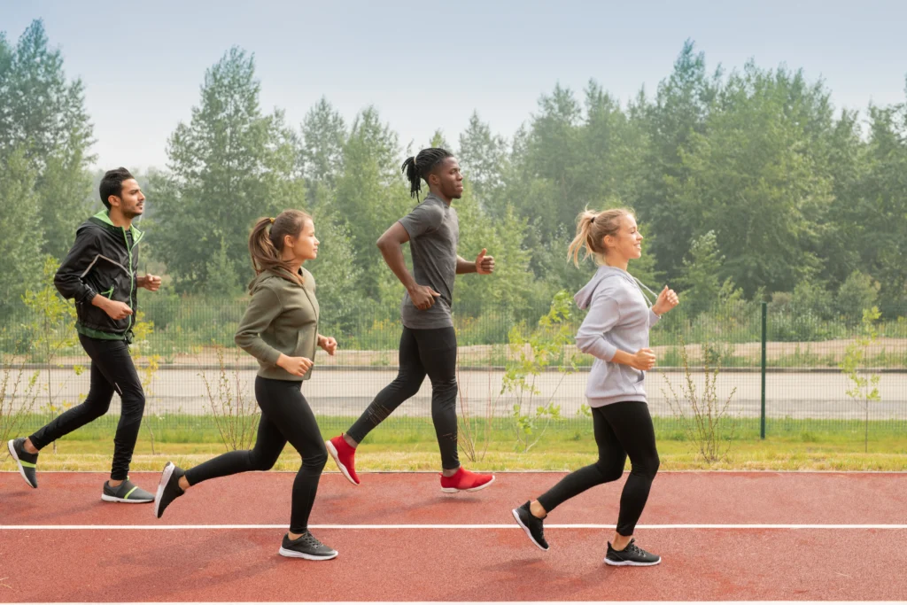 Athletes running, showcasing a healthy lifestyle to prevent back and chest pain