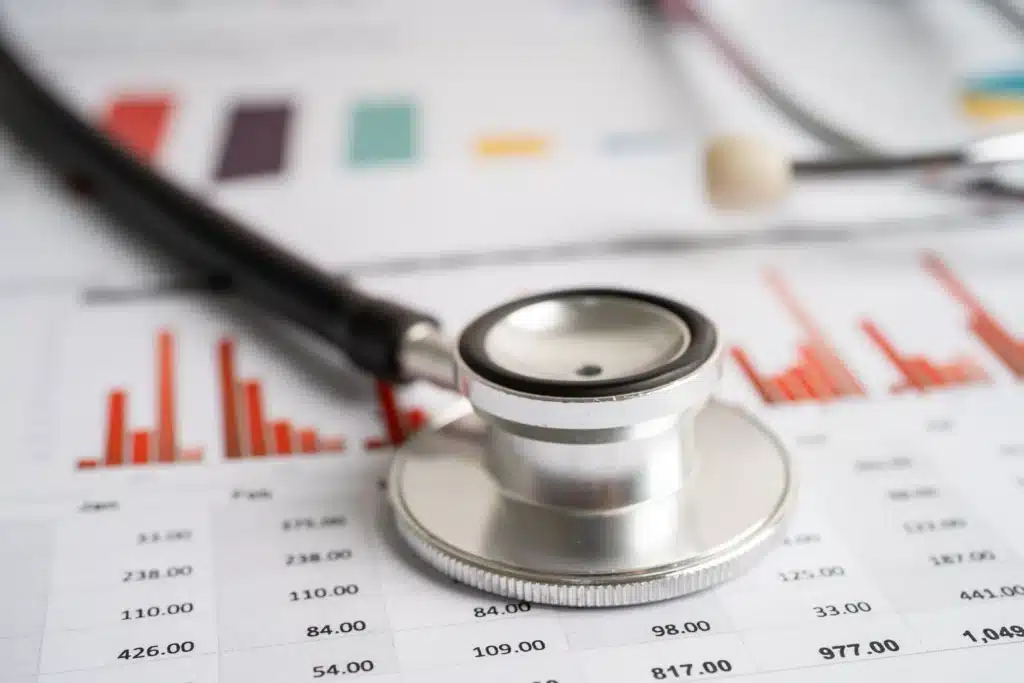 Stethoscope on financial charts representing the analysis of spine surgery costs in the USA.