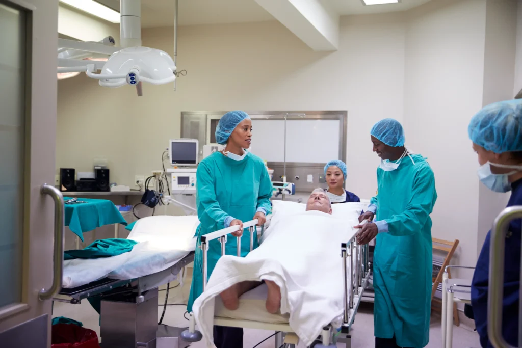 Surgical team preparing to move a senior patient post-surgery, providing essential post-operative care.