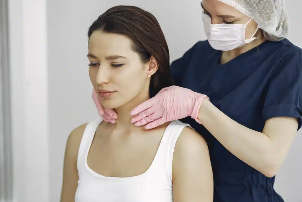 Woman consulting with a doctor for cervical neck pain treatment, considering options such as injections.