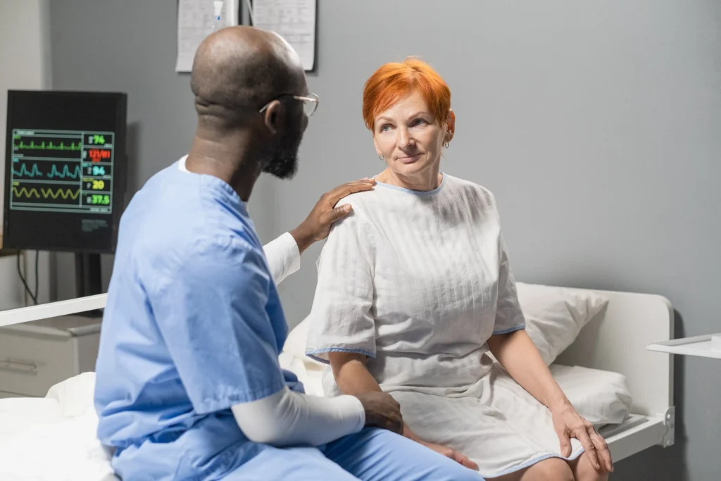 Doctor discussing SI joint pain treatment options with a patient in a hospital ward on Long Island.