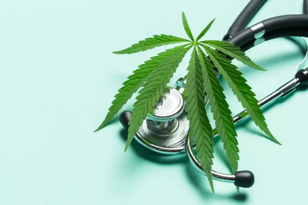 Medical marijuana leaf placed on a stethoscope symbolizing healthcare and pain management.