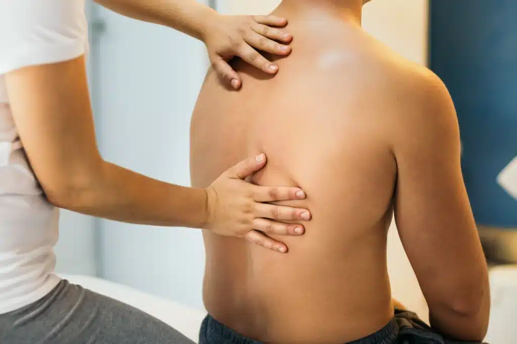 Back massage therapy session at a physiotherapy clinic for fast relief from pain and tension.